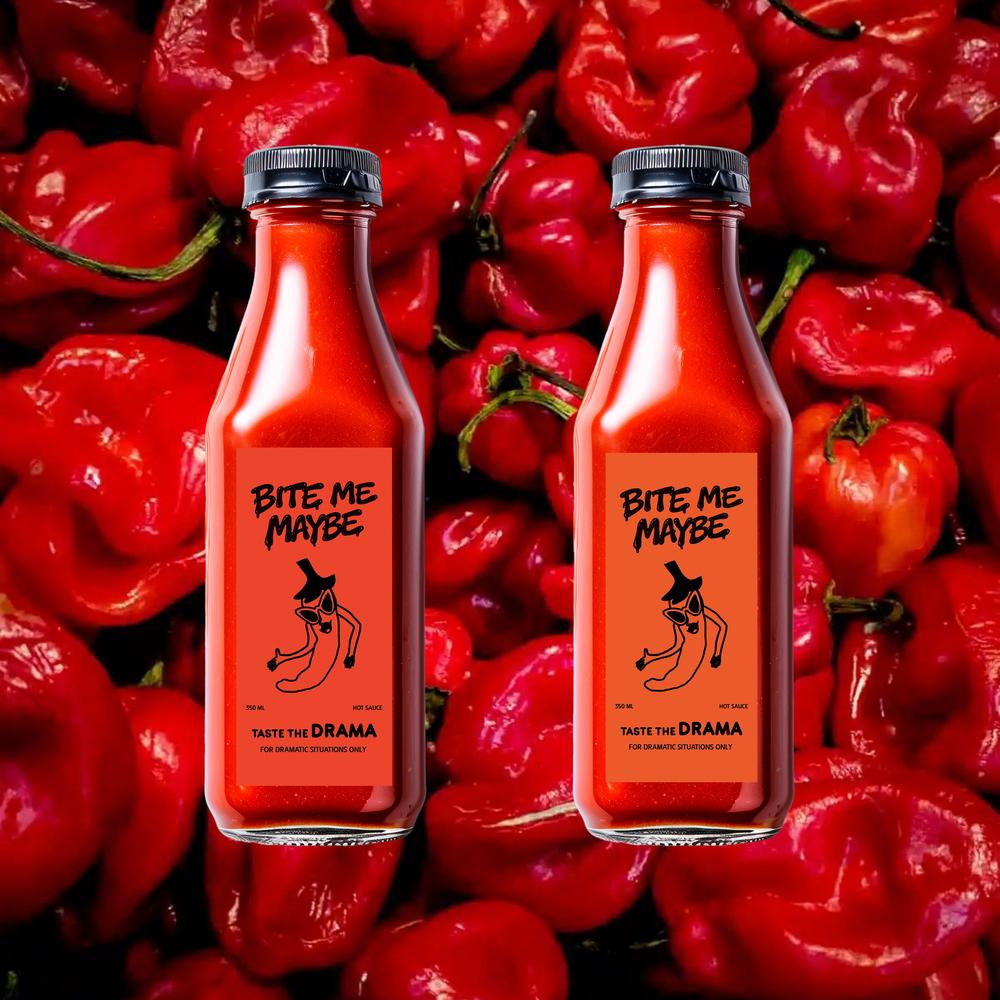 Top-down view of two hot sauce bottles lying on a bed of red chilies, showcasing the distinct naming conventions on the labels.