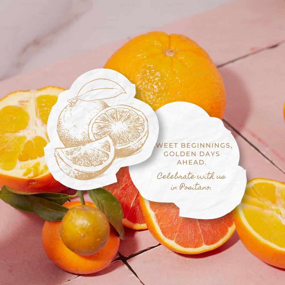 Creative die-cut citrus-shaped wedding save-the-dates arranged with fresh orange slices.